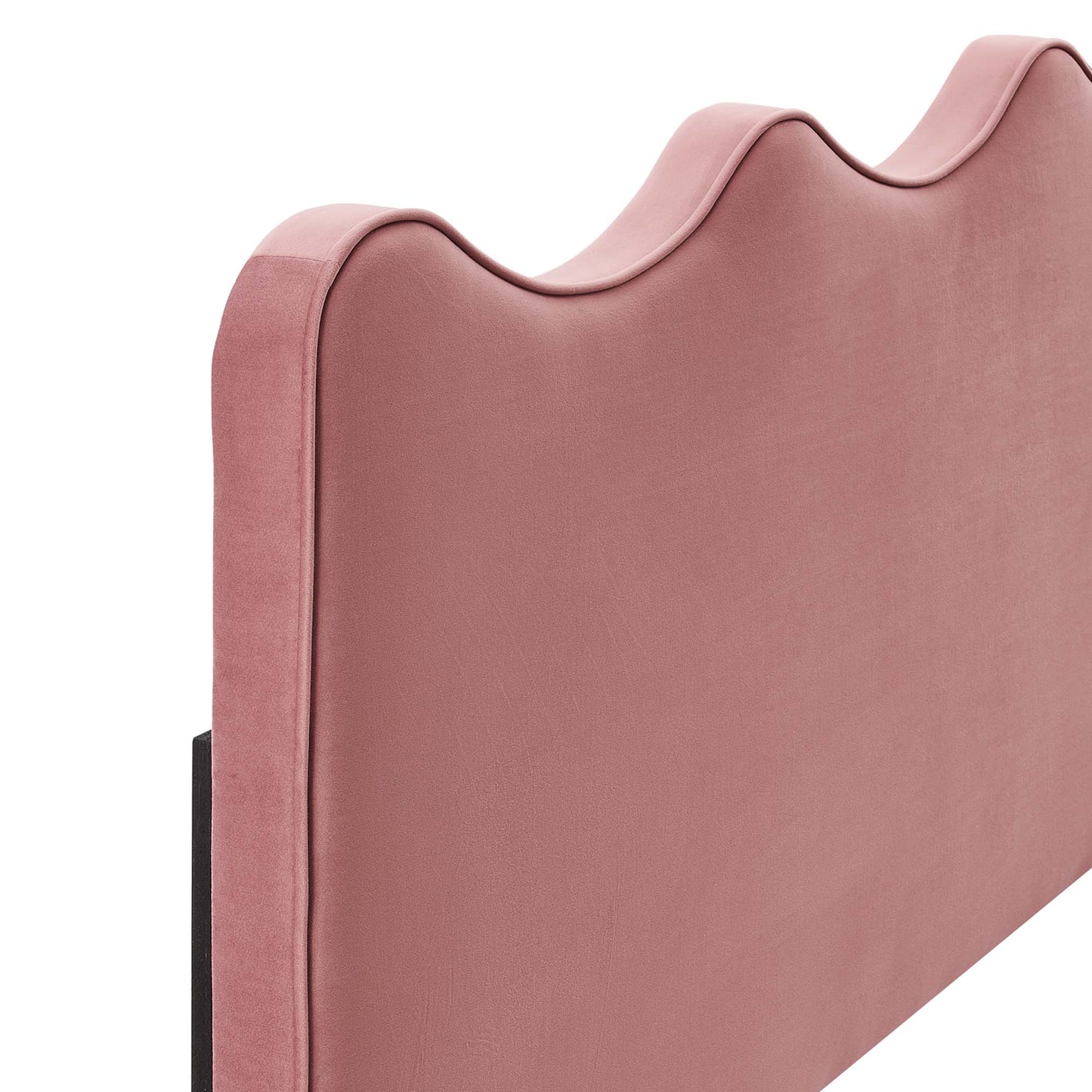 Red velvet upholstered headboard with a scalloped wavy top and slim black legs.