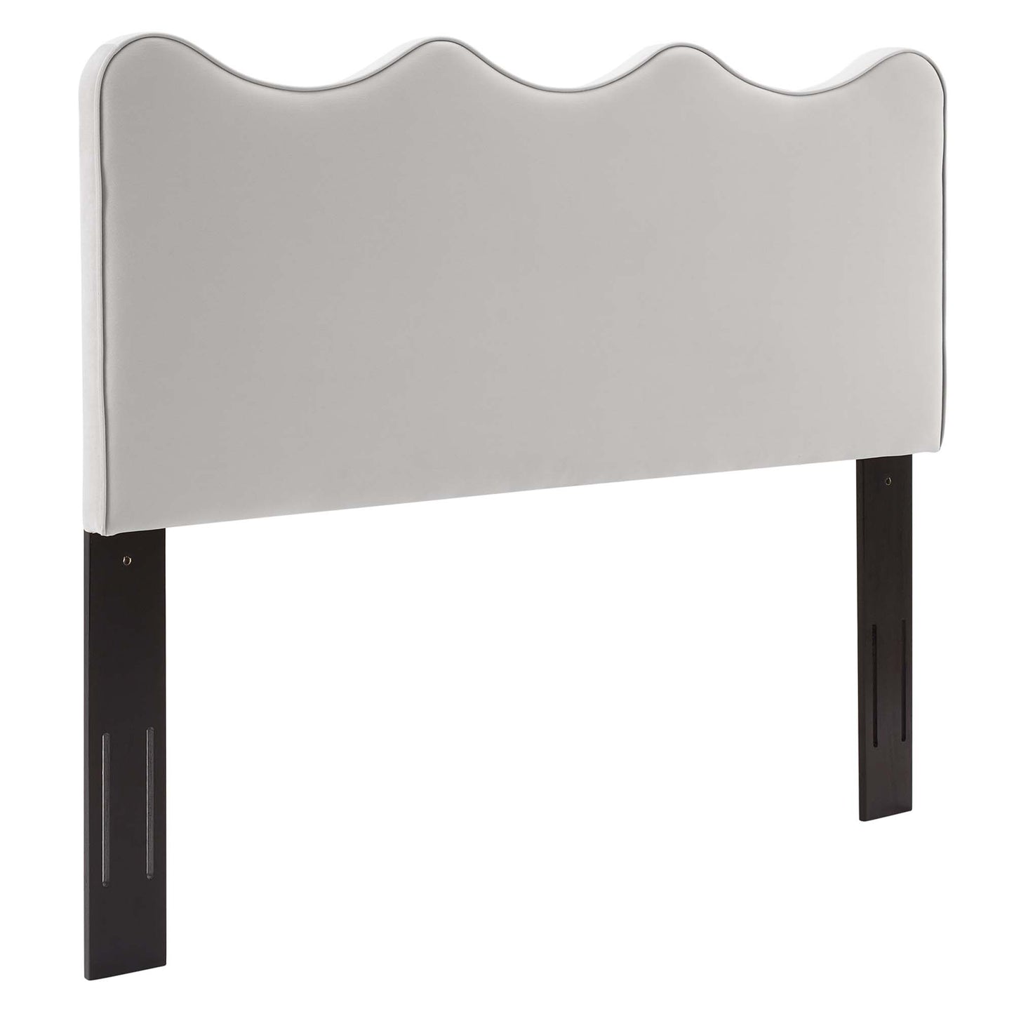 Light gray upholstered headboard with a wavy top and dark wood legs for a modern bed.