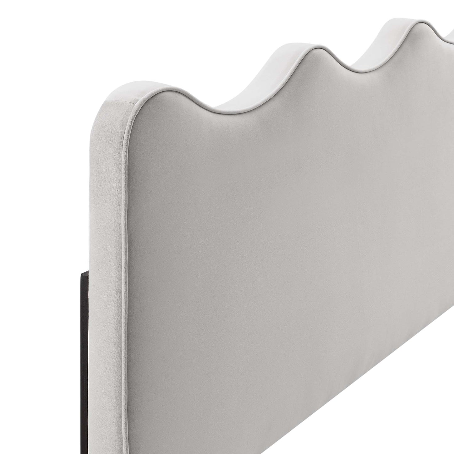 Light gray fabric upholstered headboard with curved wave top and white piping along edges.