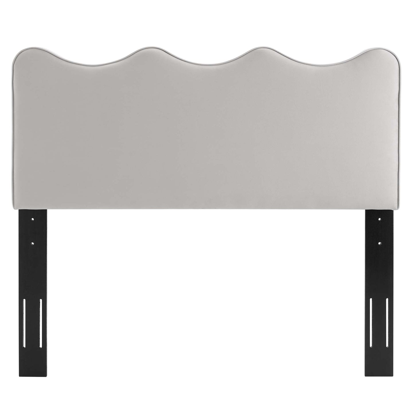 Light gray upholstered headboard with a scalloped wavy top & black metal legs.