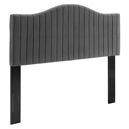 Charcoal gray upholstered headboard with curved arch and vertical channel quilting, supported by black metal legs.
