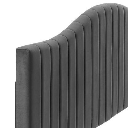 Dark gray velvet upholstered headboard with vertical channel tufting and curved top.