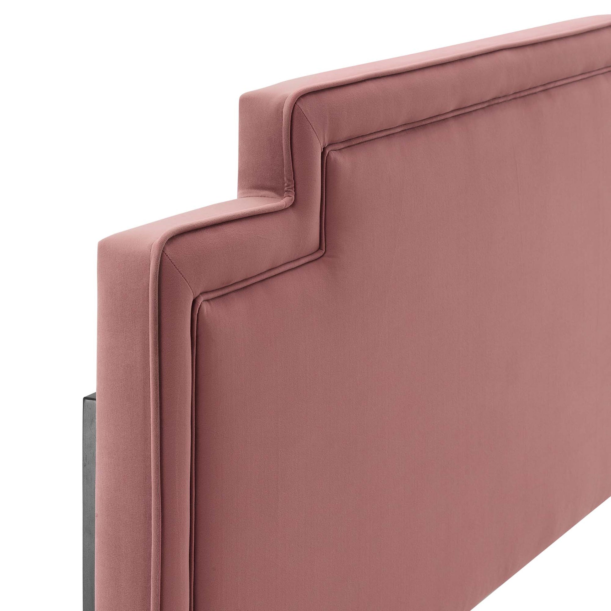Dusty rose velvet headboard with a padded back panel, stepped edge design, piping detail, and metal legs.