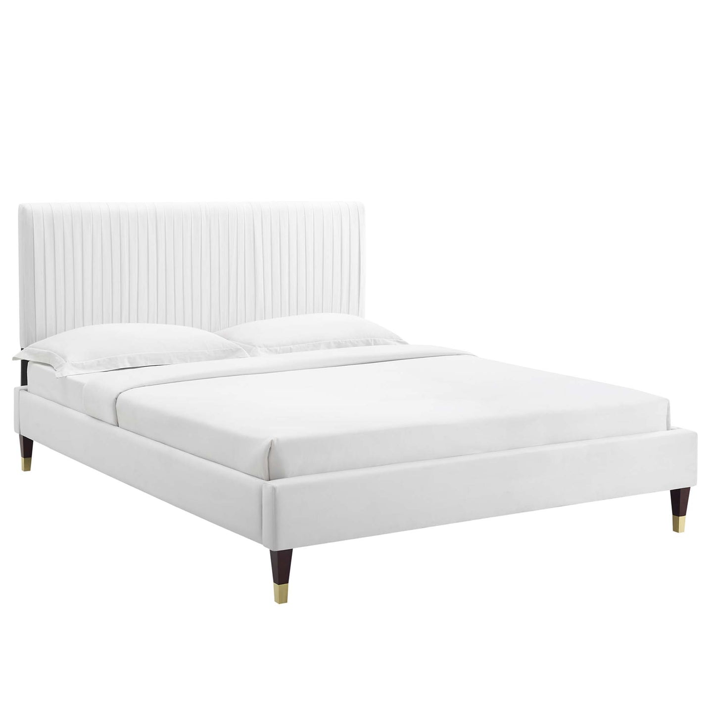White upholstered platform bed with tall vertical channel-tufted headboard, low base & tapered wooden legs.