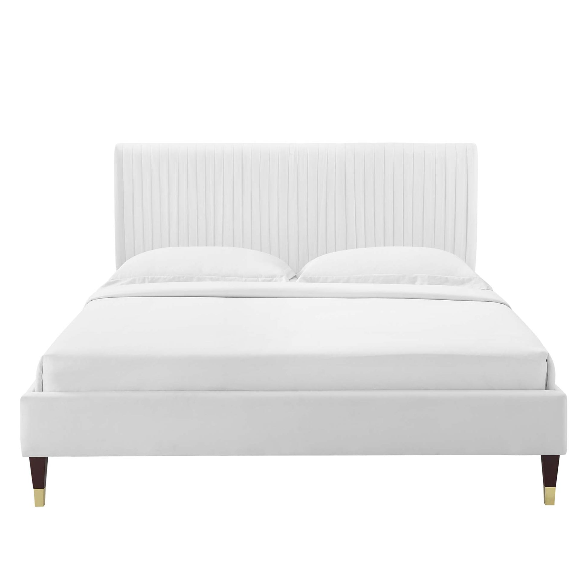 White upholstered platform bed with tall vertical-channel headboard, clean lines, and wood legs with brass caps.