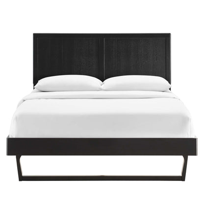 Modern black platform bed with tall paneled headboard and slim base, white bedding and two pillows.