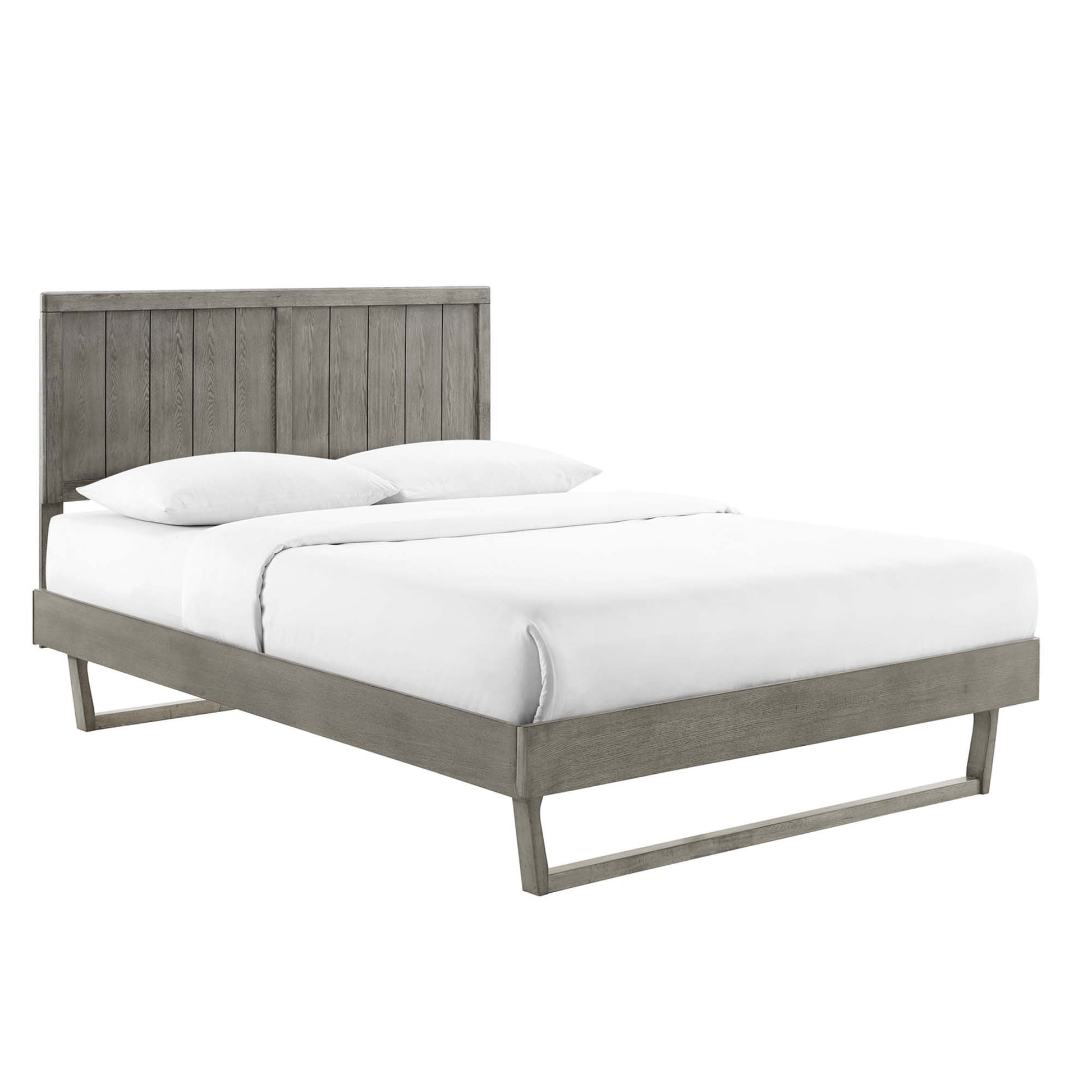 Gray weathered wood platform bed with tall vertical slat headboard & angular legs, white bedding.