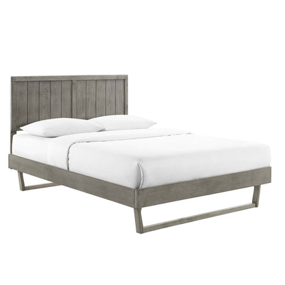 Gray weathered wood platform bed with tall vertical slat headboard & angular legs, white bedding.
