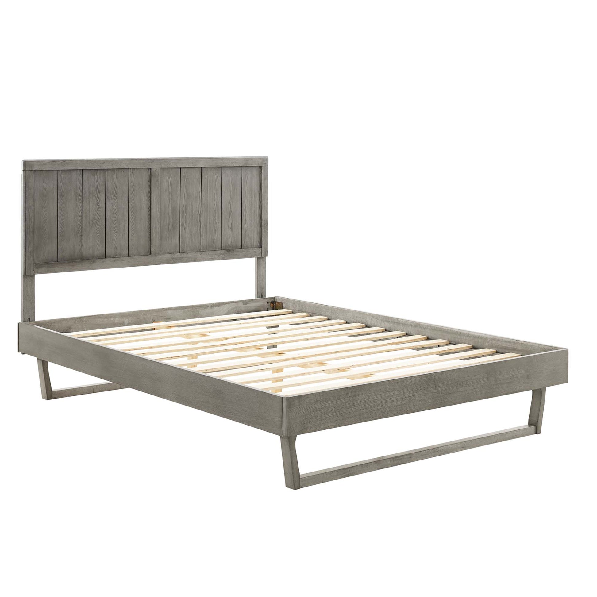 Weathered gray wooden platform bed with tall vertical-panel headboard, low frame, and slatted mattress support.