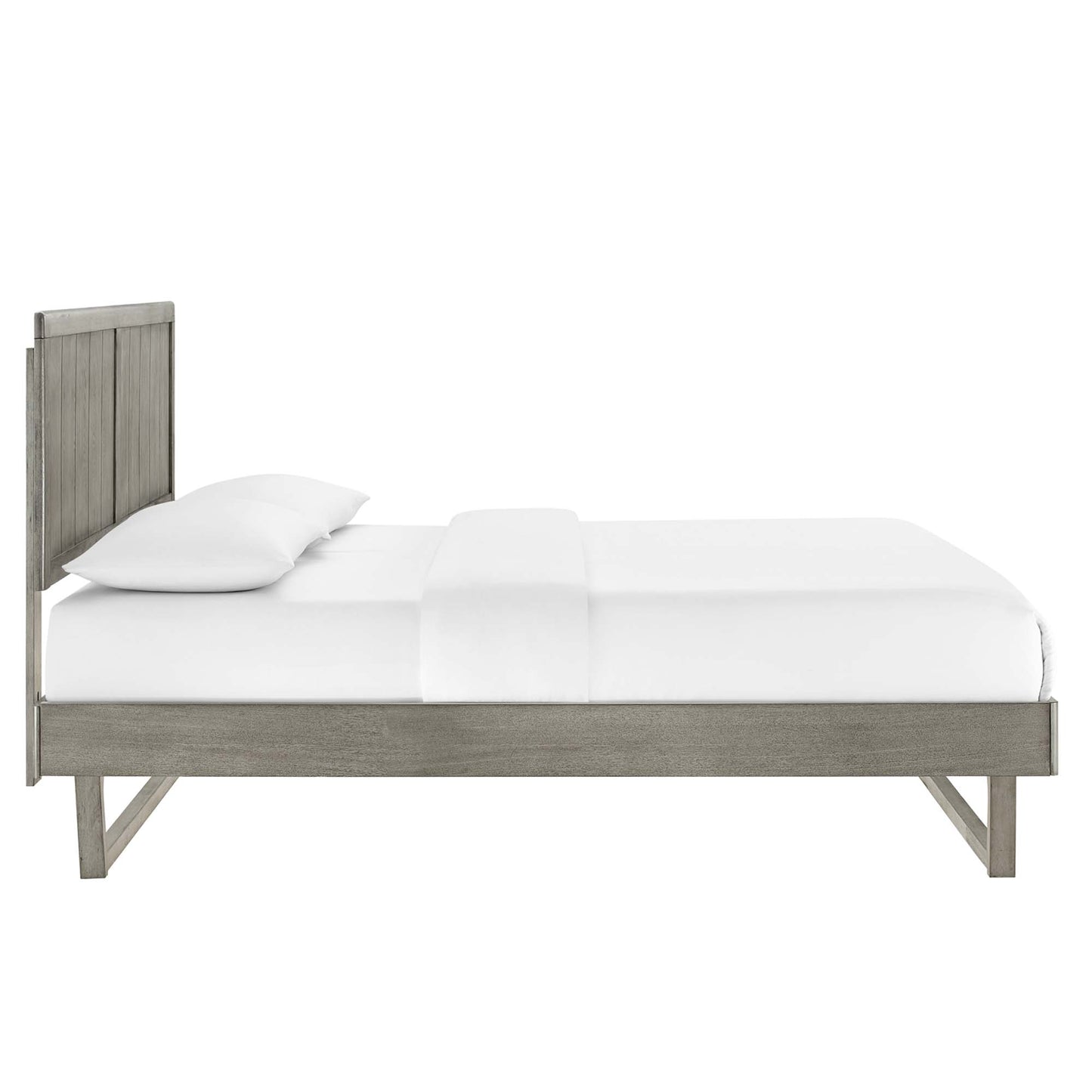 Grey-washed wood platform bed with tall slatted headboard and white bedding.