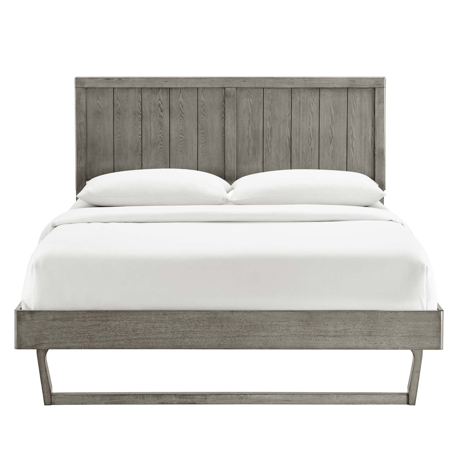 Grey weathered wood platform bed with tall vertical-plank headboard and slim leg base, white bedding.