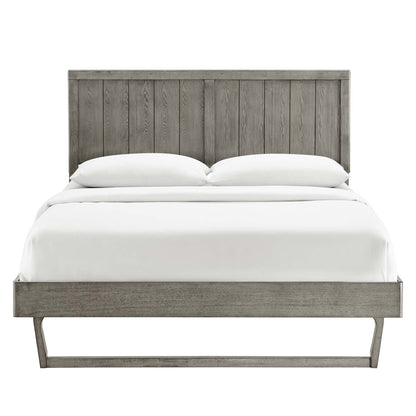 Grey weathered wood platform bed with tall vertical-plank headboard and slim leg base, white bedding.
