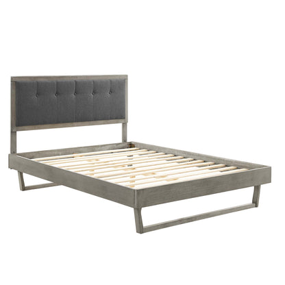 Gray wood platform bed with an angular frame, slatted foundation and low-profile legs in a modern rustic style.