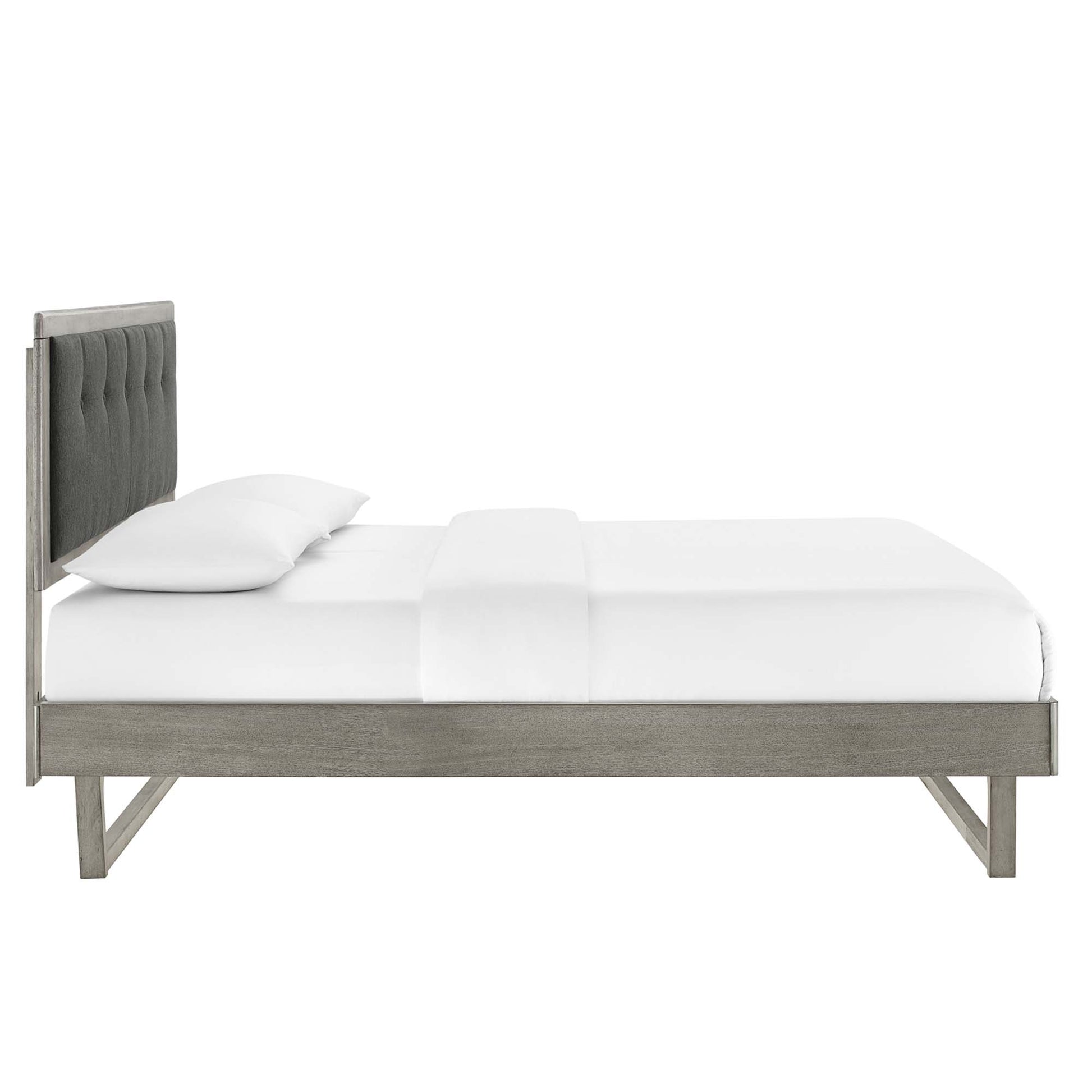Platform bed with weathered gray wood frame and angular design, white bedding.