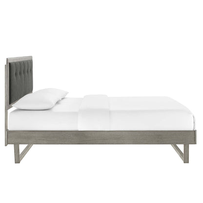 Platform bed with weathered gray wood frame and angular design, white bedding.