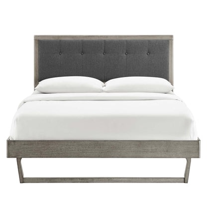 Gray wood king platform bed with an angular frame and white linens.