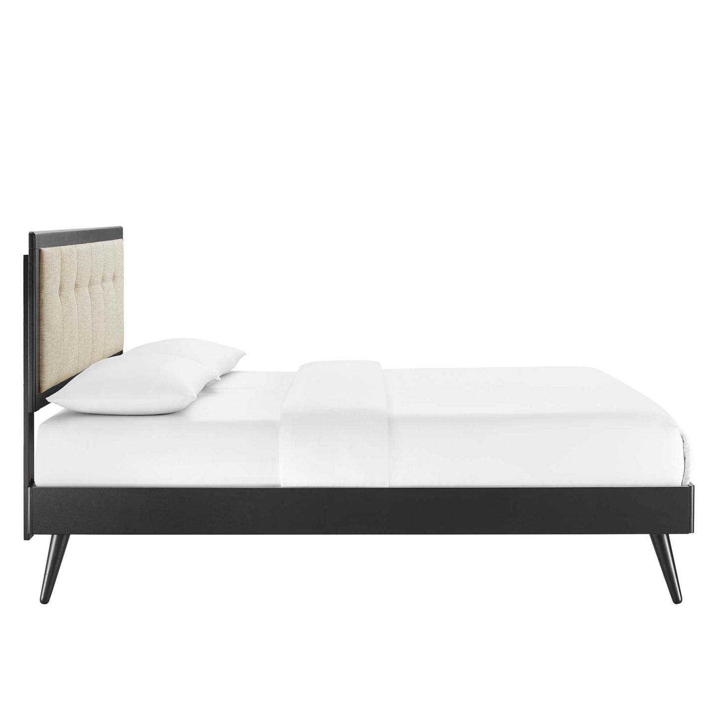 Modern brown platform bed with a beige tufted headboard, slim splayed legs, white bedding and pillows.