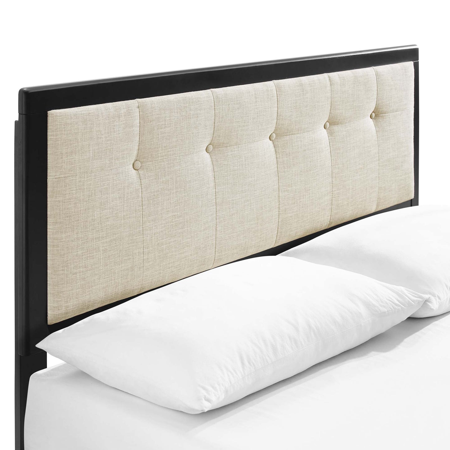 Brown wood king platform bed with splayed legs and a beige tufted headboard with button-tufted panels on white bedding.