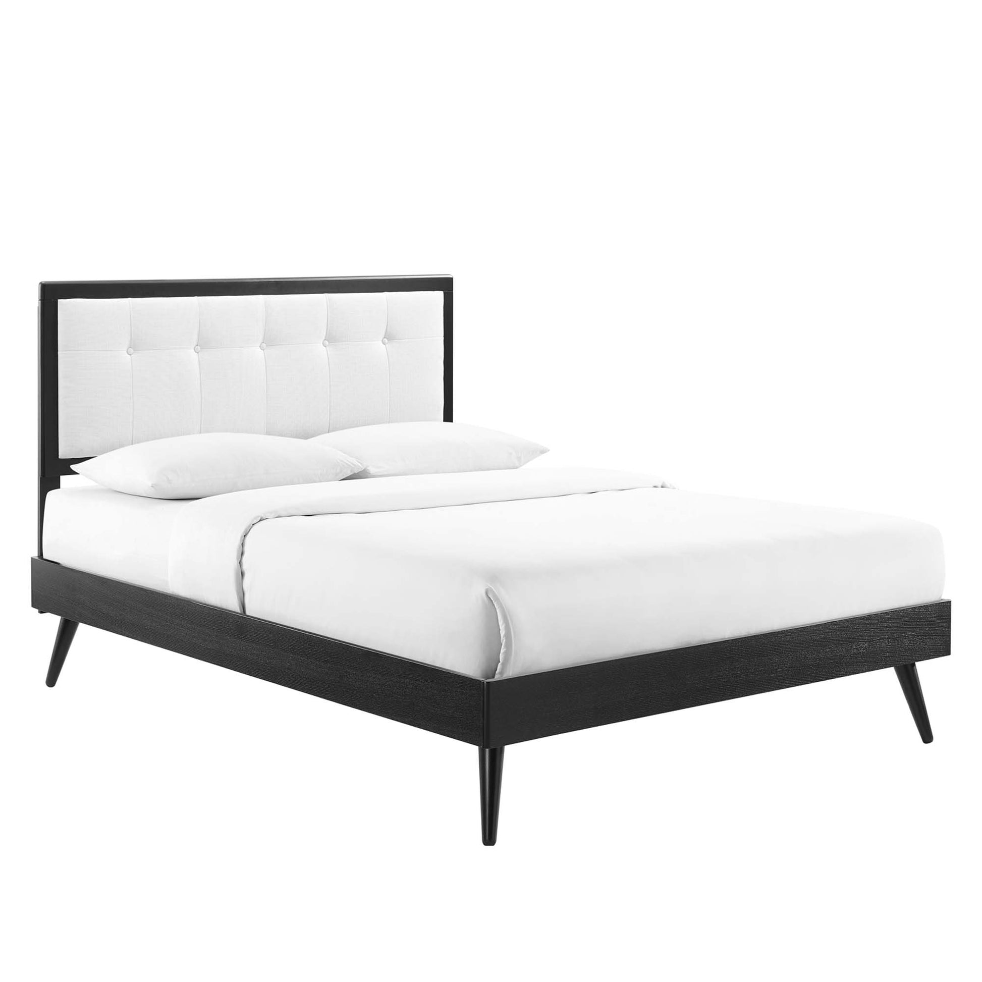 Willow wood king platform bed with splayed legs, white tufted upholstered headboard and white bedding.
