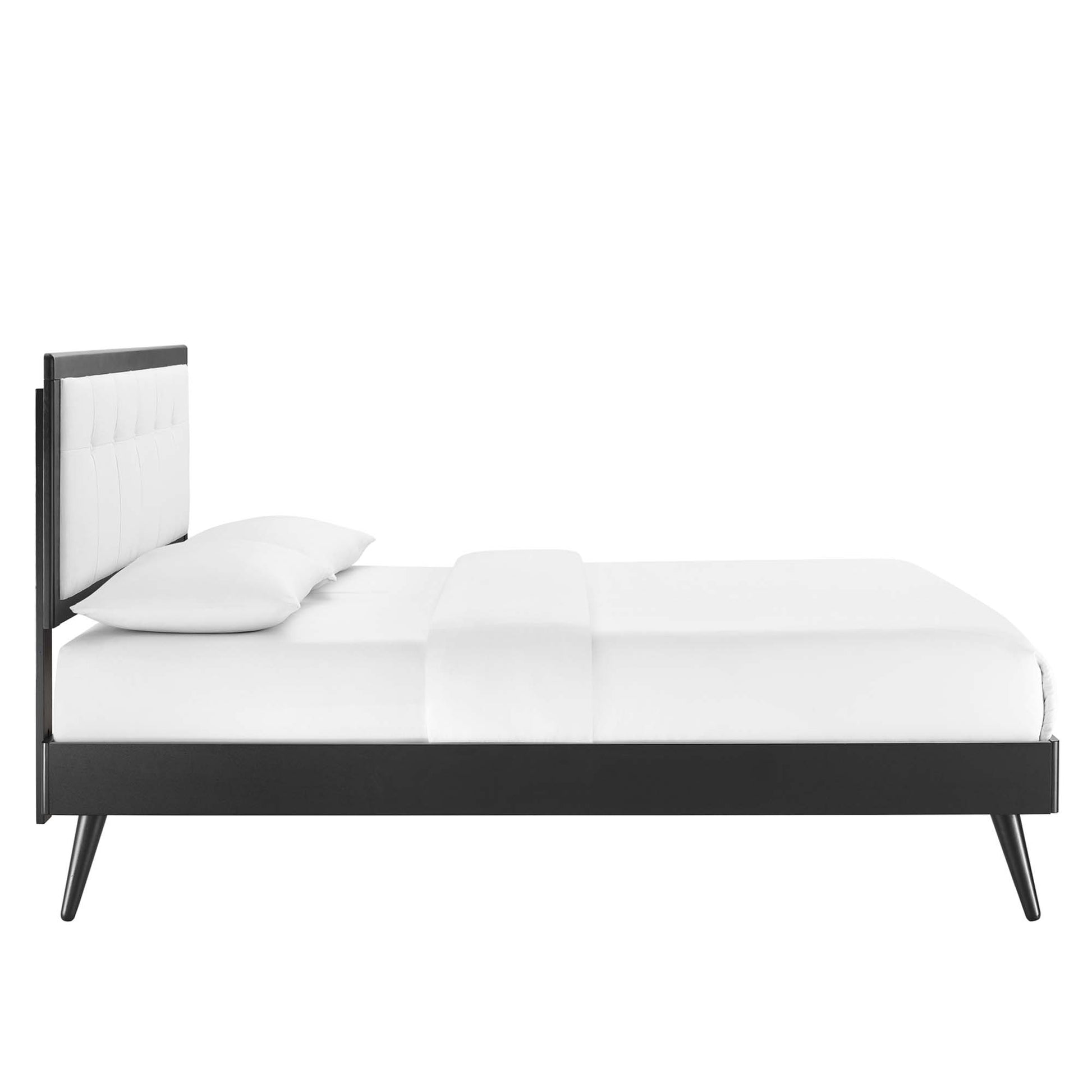White king platform bed with splayed legs and white bedding.