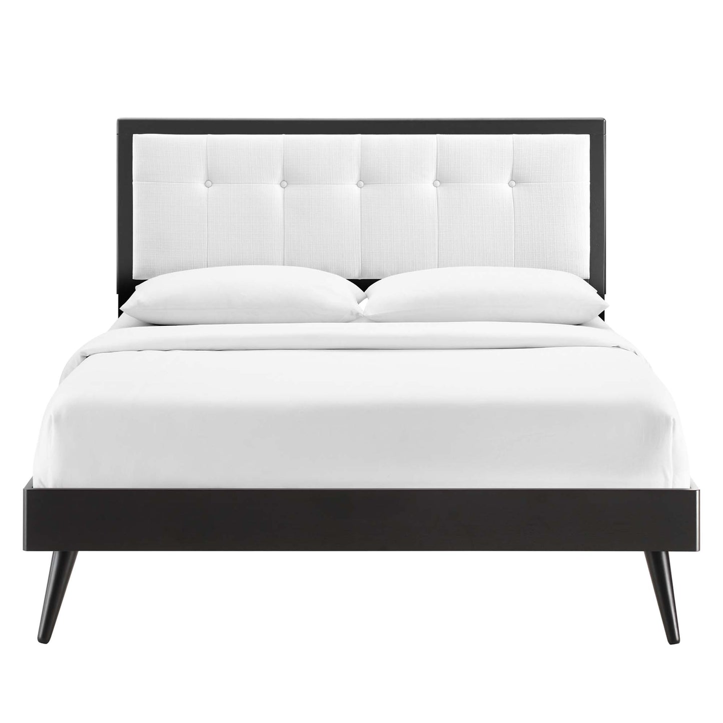 White wood king platform bed with splayed legs and white bedding.