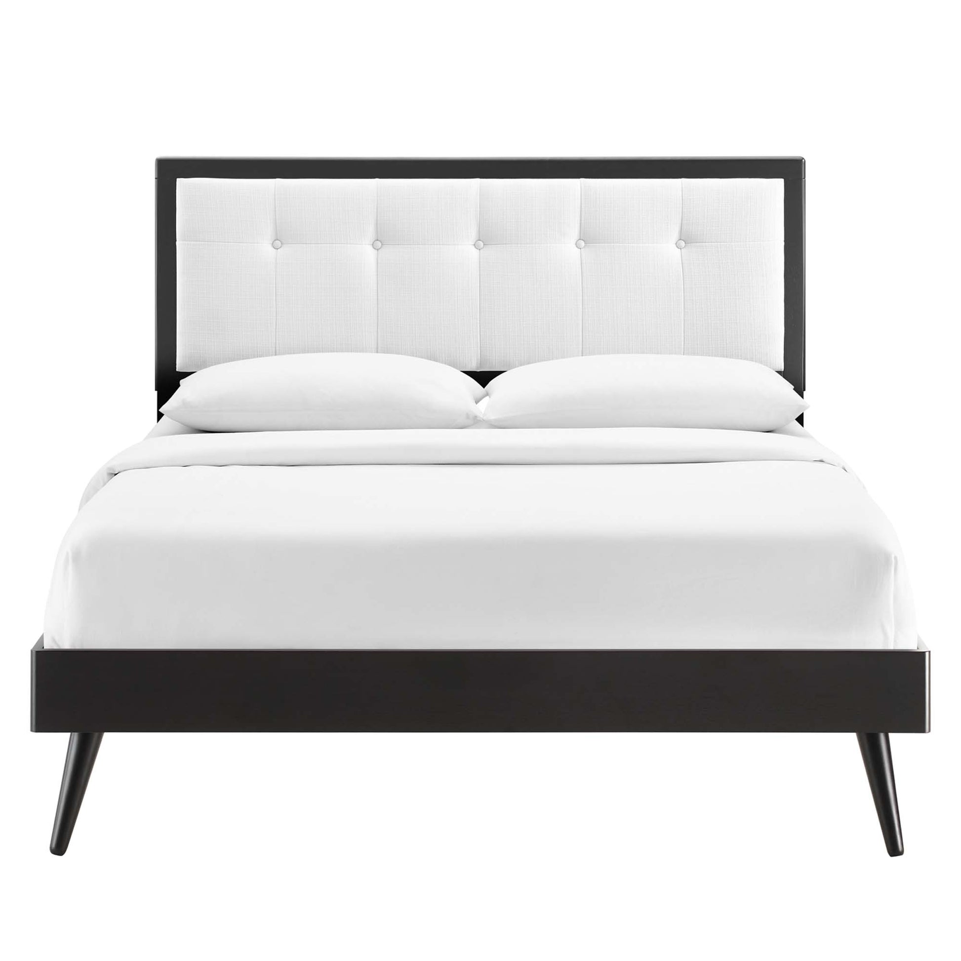 White wood king platform bed with splayed legs and white bedding.