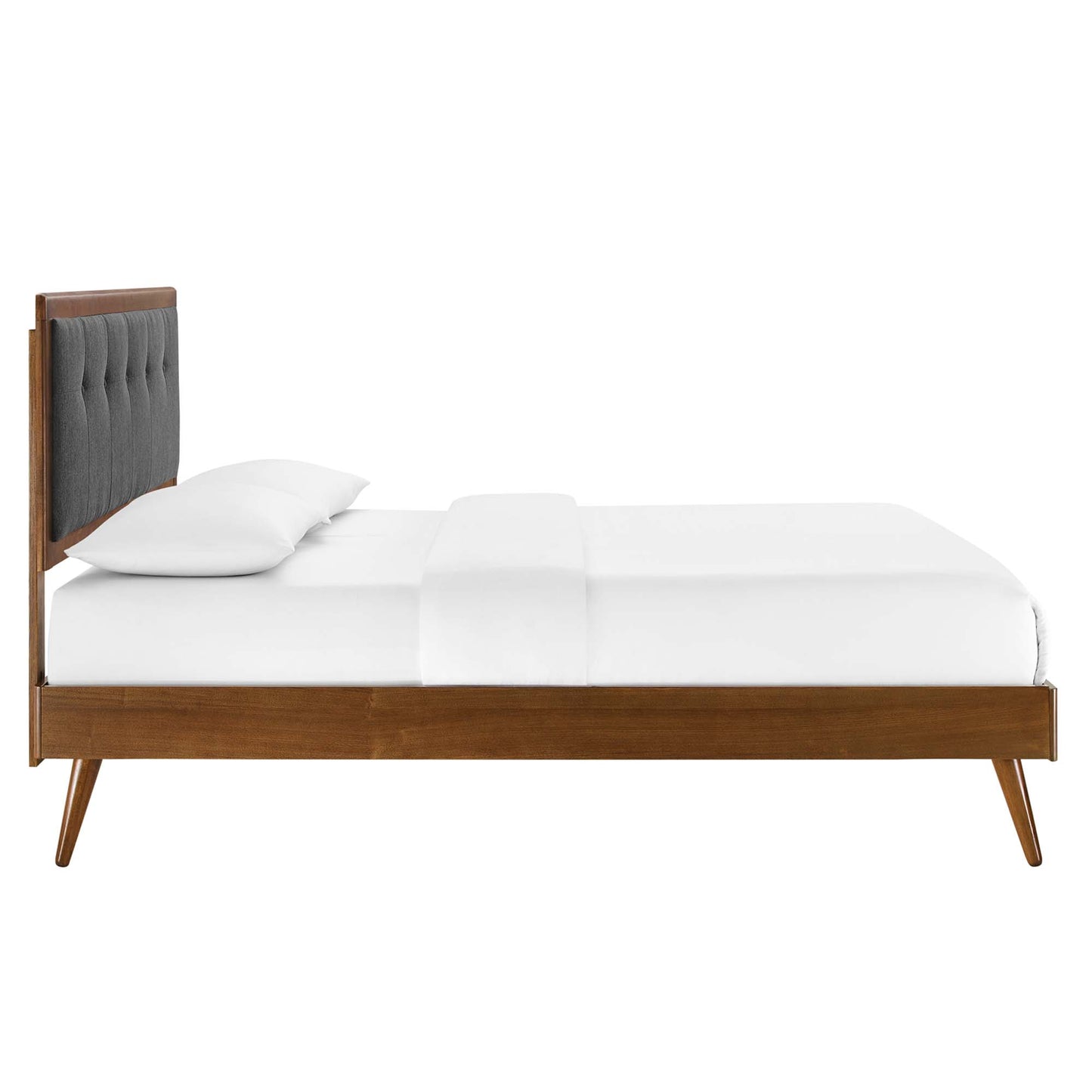 Walnut wood bed frame with gray tufted headboard and white bedding.