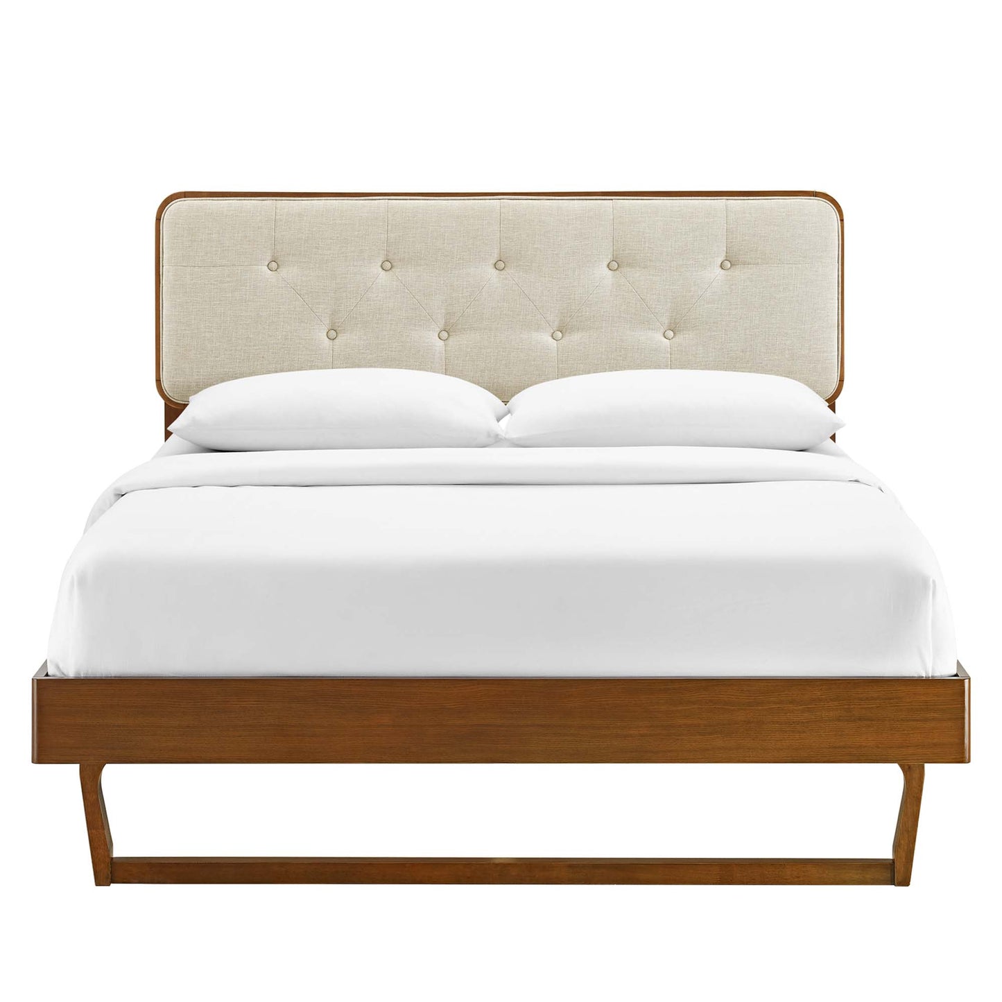 Walnut wood platform bed with beige tufted headboard, white bedding, mid-century modern design.