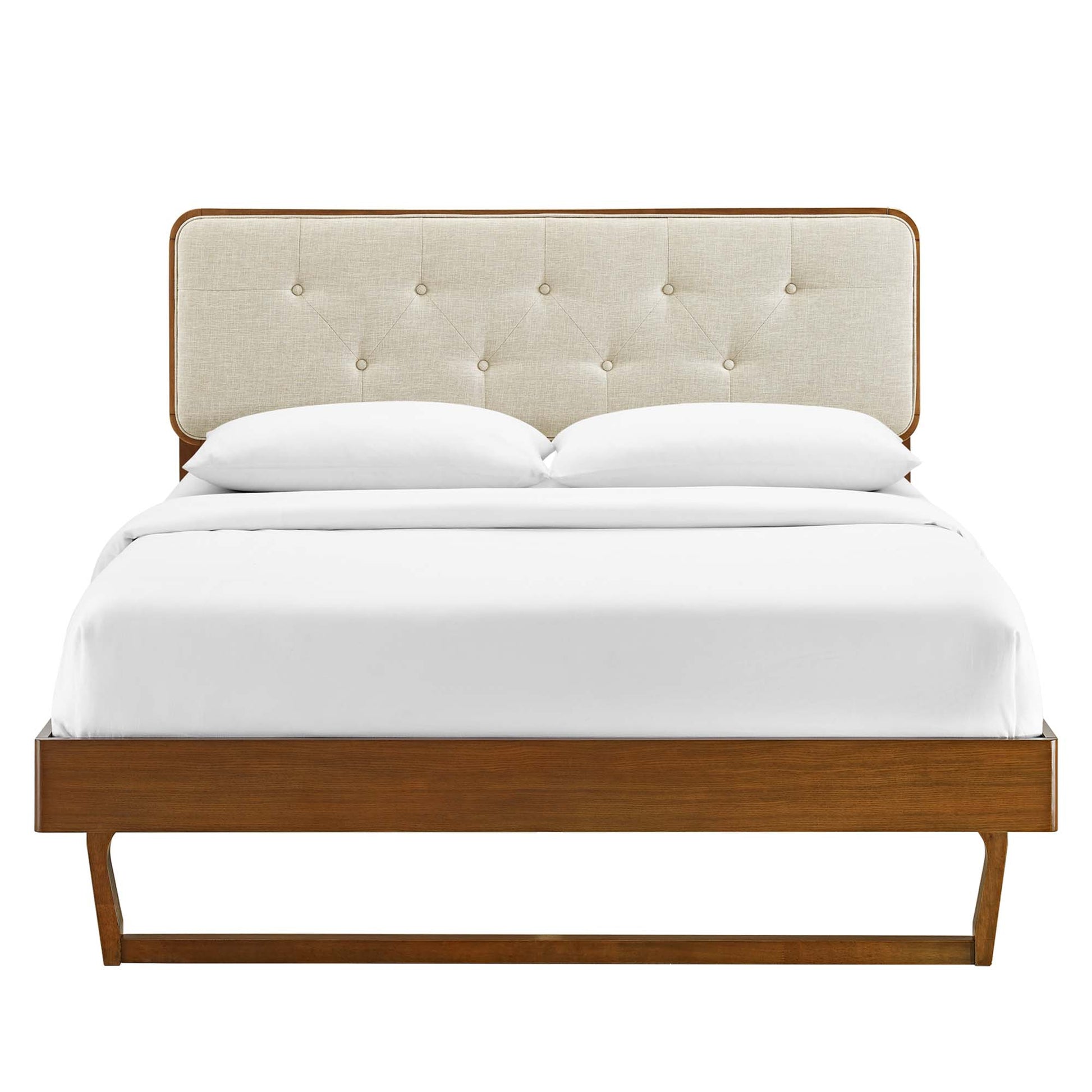 Walnut wood platform bed with beige tufted upholstered headboard and white bedding.