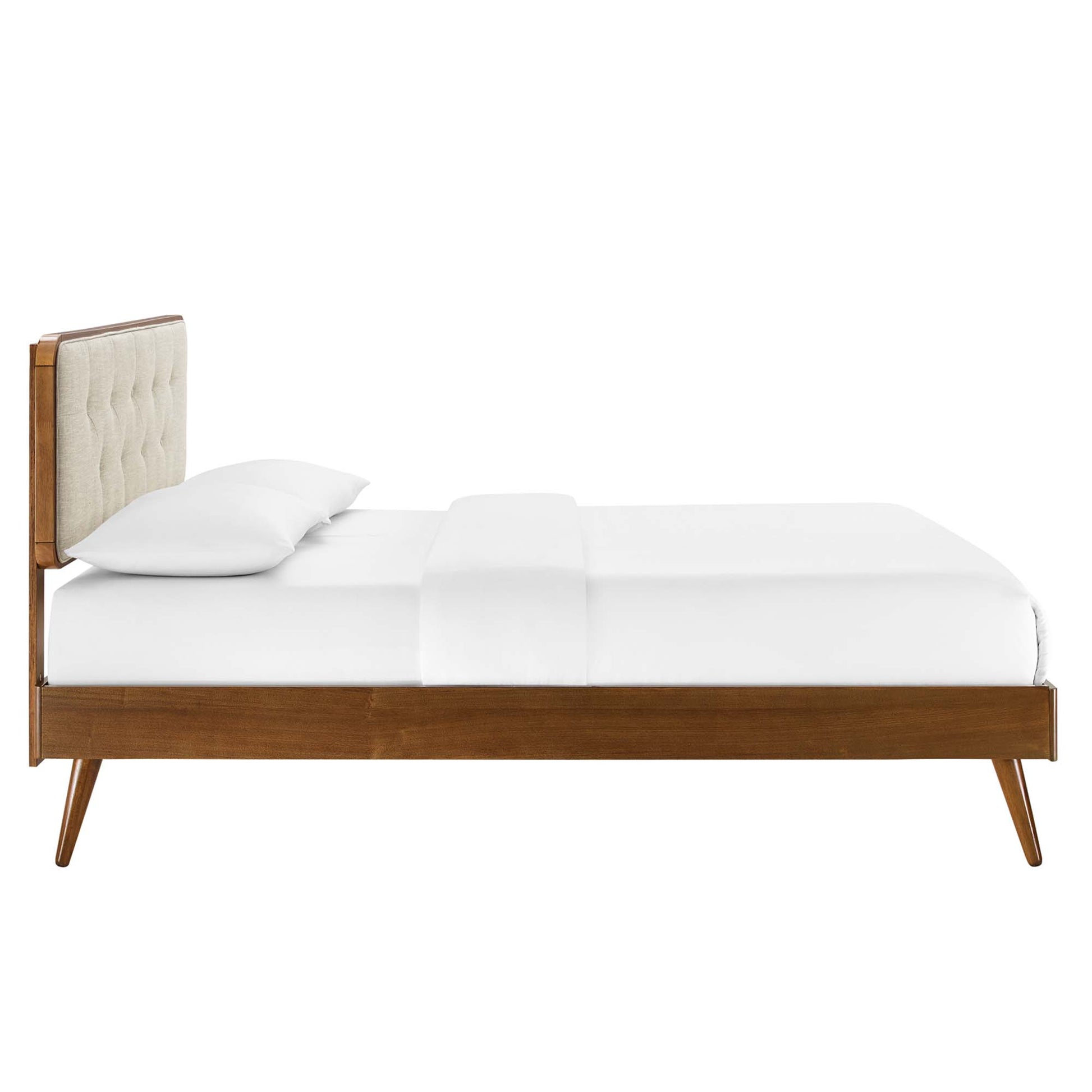 Walnut wood twin platform bed with splayed legs and white linens, mid-century design.