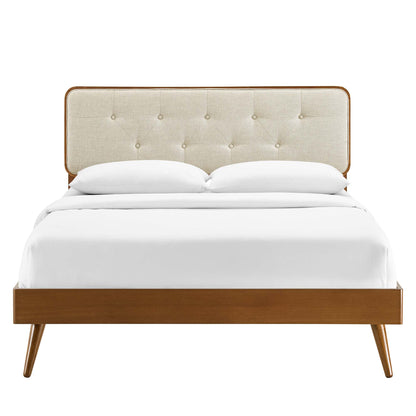 Walnut wood twin platform bed with splayed legs and white bedding.