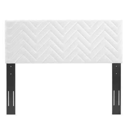 White upholstered headboard with chevron quilted pattern on dark metal legs.