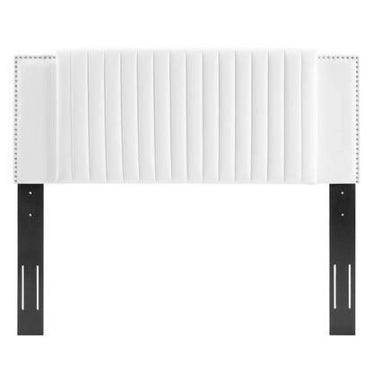 White upholstered headboard with vertical channel tufting and nailhead trim, mounted on black metal brackets.