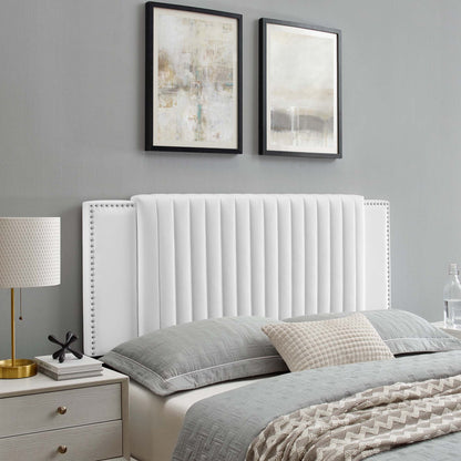 White upholstered twin headboard with a tall channel-tufted panel and nailhead trim.
