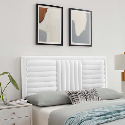 White tufted headboard with vertical panels, gray bedding, striped lumbar pillow, pale blue throw; abstract art prints above.