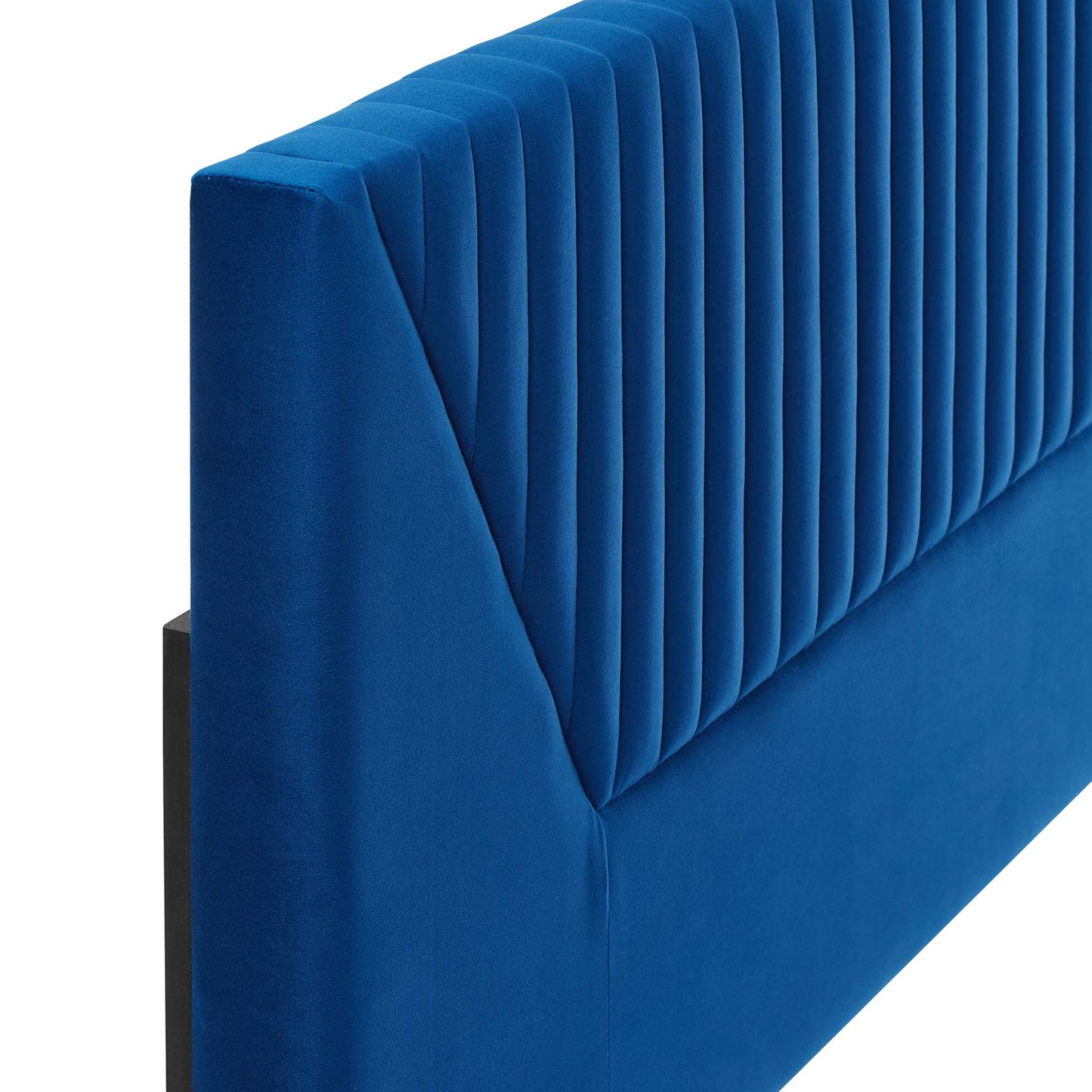 Navy velvet upholstered twin headboard with vertical channel tufting and dark legs.