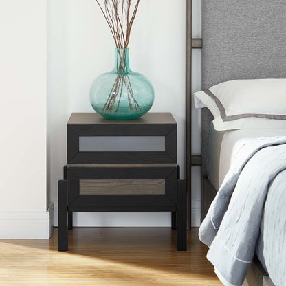 Modern two-drawer nightstand in dark wood with oak fronts, topped by a turquoise glass vase with branches.