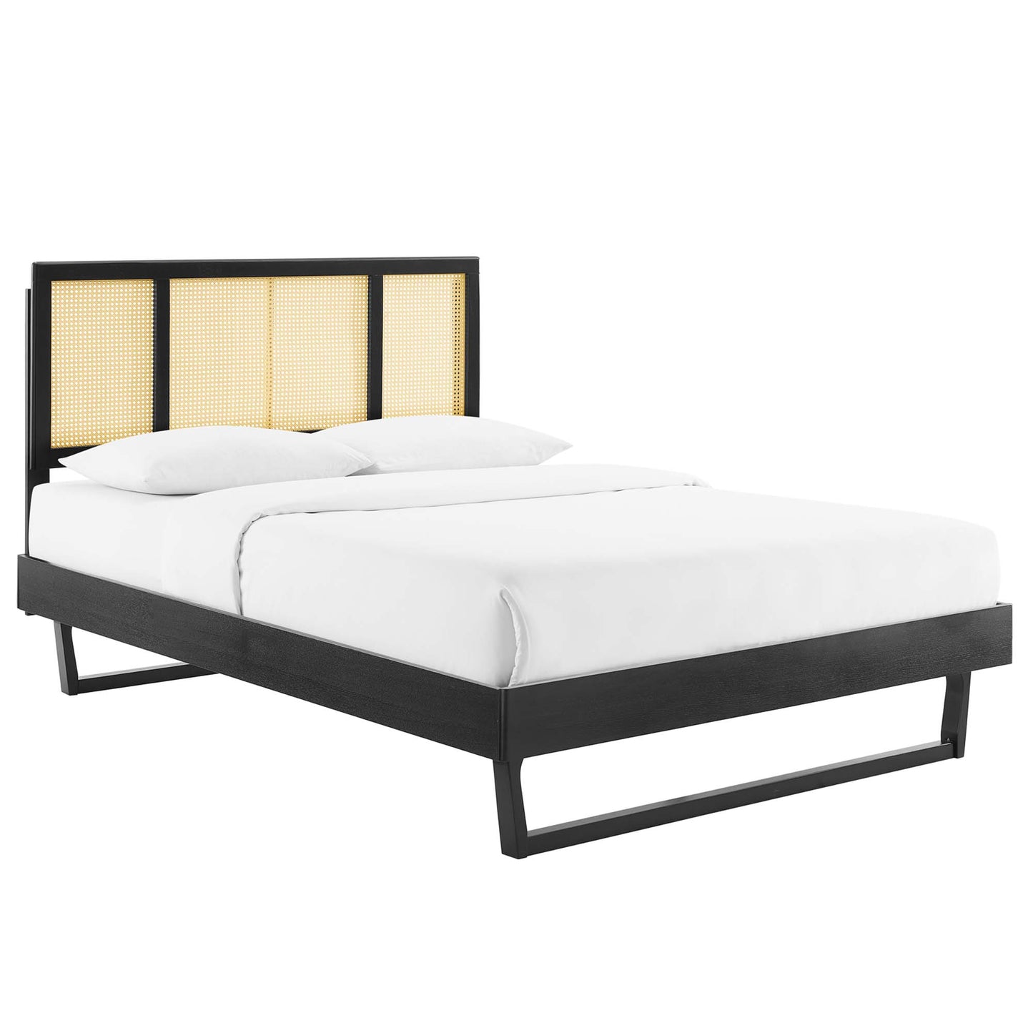 Black platform bed with caned headboard panels and white bedding.