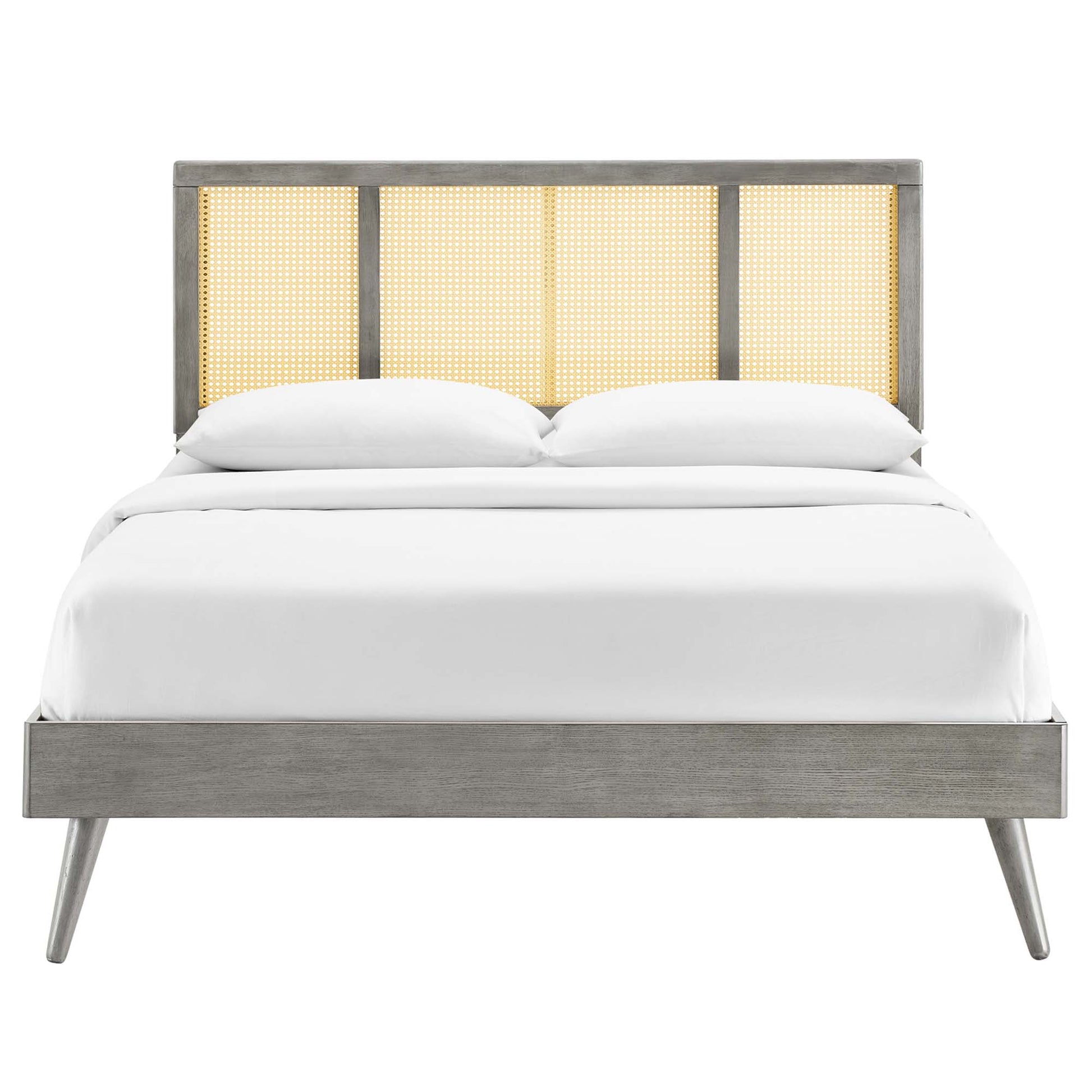 Mid-century modern grey wood full platform bed with caned headboard panels and splayed legs, white bedding.