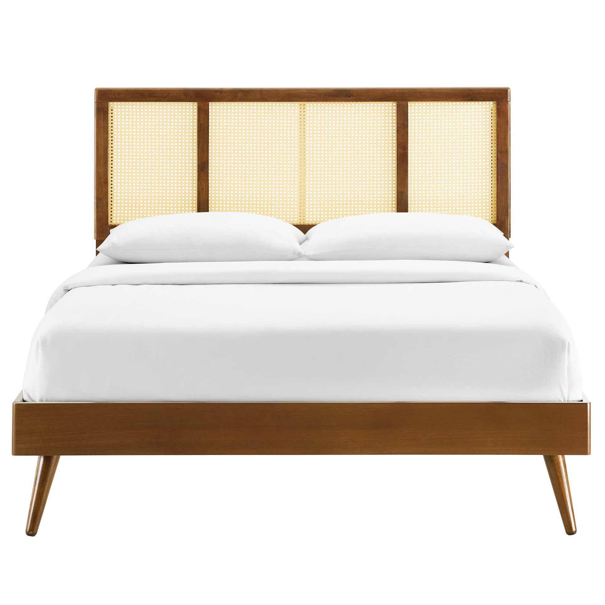 Walnut wood bed with cane-panel headboard & white bedding, full platform bed with mid-century modern style and splayed legs.