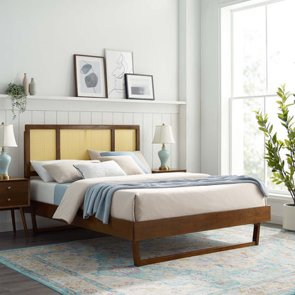 Mid-century wooden bed with woven cane headboard, beige linens and blue throw; matching nightstands, turquoise lamps, large window, rug.