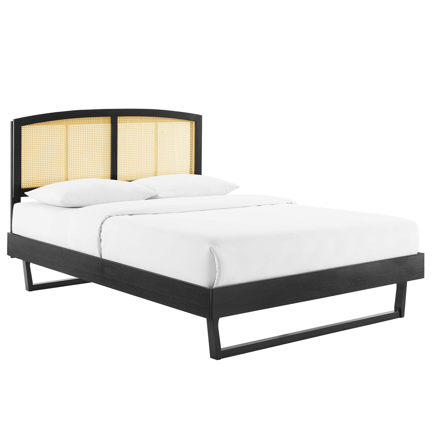Black platform bed with three-panel curved cane headboard, low-profile frame and white bedding.