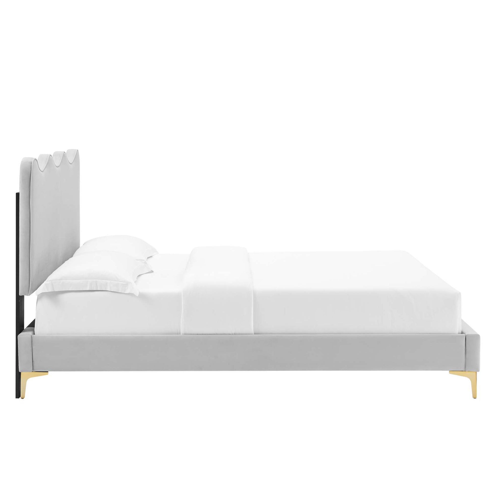 Gray fabric twin platform bed with tall, segmented headboard and gold legs, topped with white bedding.