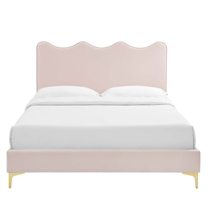 Pastel pink upholstered bed with scalloped wave headboard, white bedding, pale pink frame & gold legs.