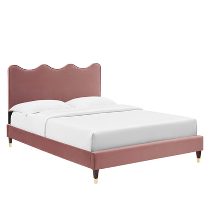 Dusty rose velvet platform bed with a scalloped headboard and gold-tipped legs, white bedding.