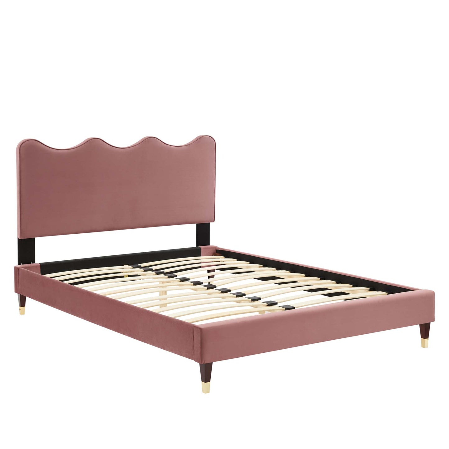 Dusty-pink velvet platform bed with scalloped headboard, black rails, wooden slats, & gold-tipped tapered legs.