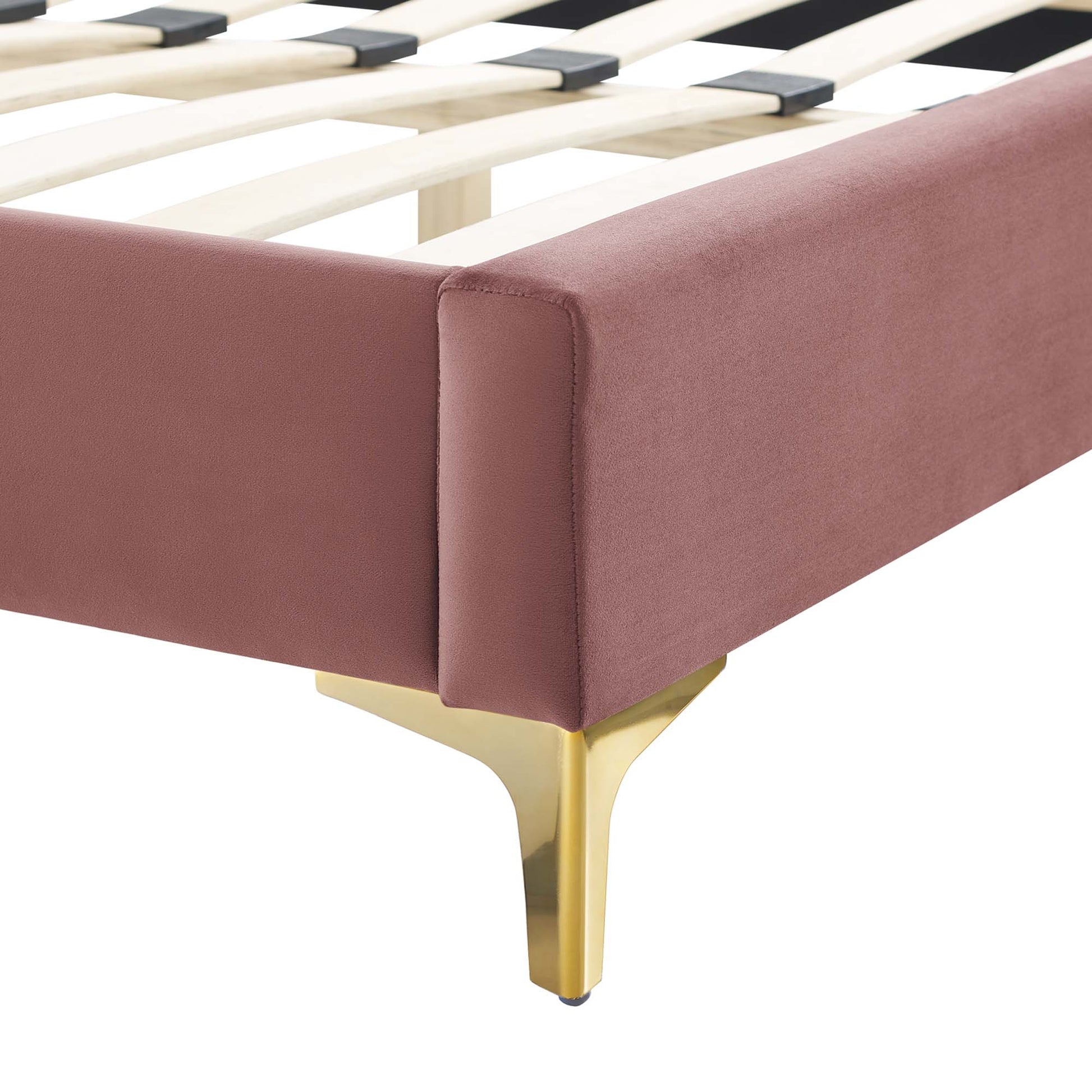 Dusty pink upholstered full platform bed with gold metal legs and wooden slats