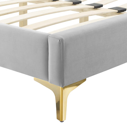 Modern full-size platform bed frame with gray velvet upholstery, natural wood slats, and gold-tone metal legs.
