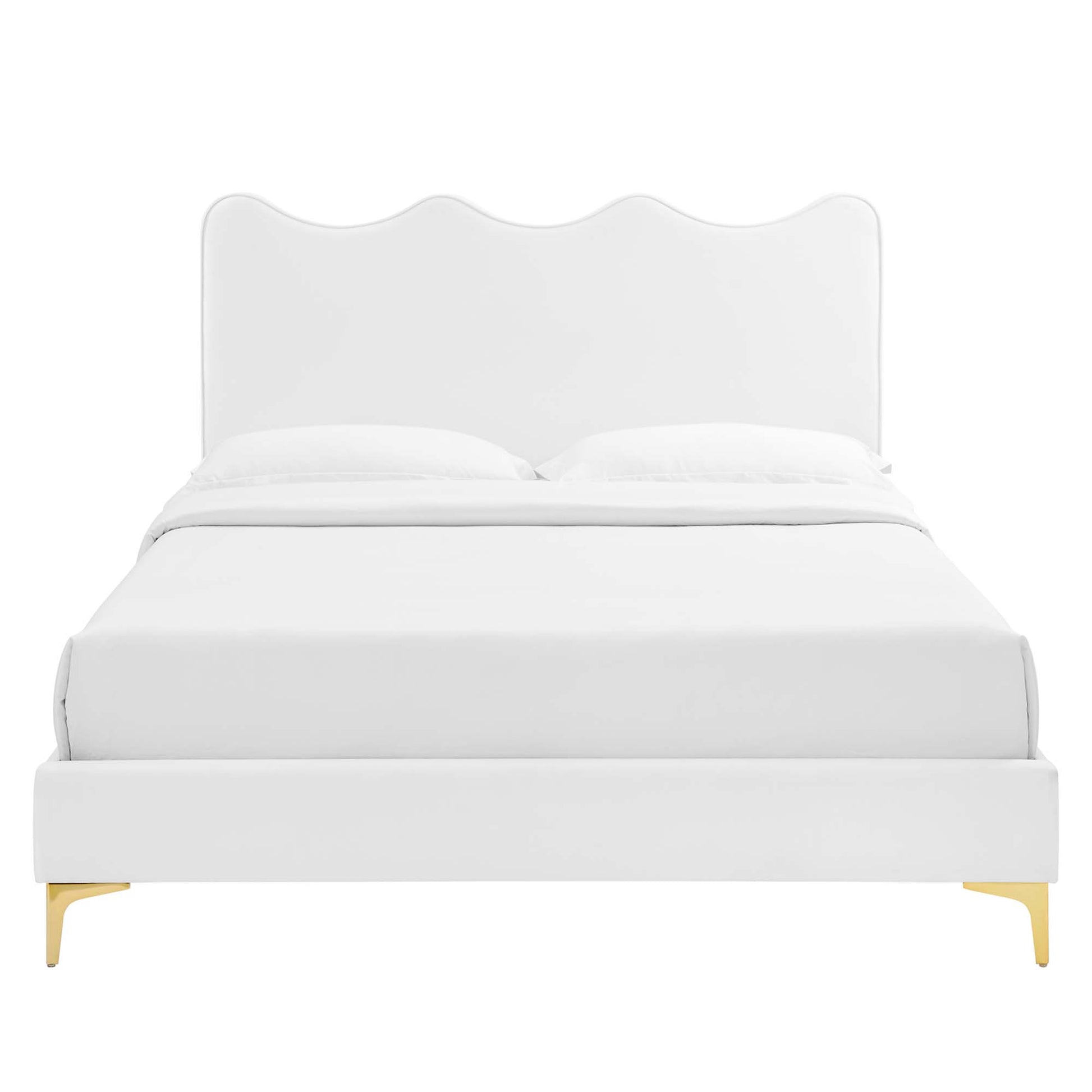 White upholstered platform bed with a scalloped wave headboard, white bedding, and gold-tone legs.