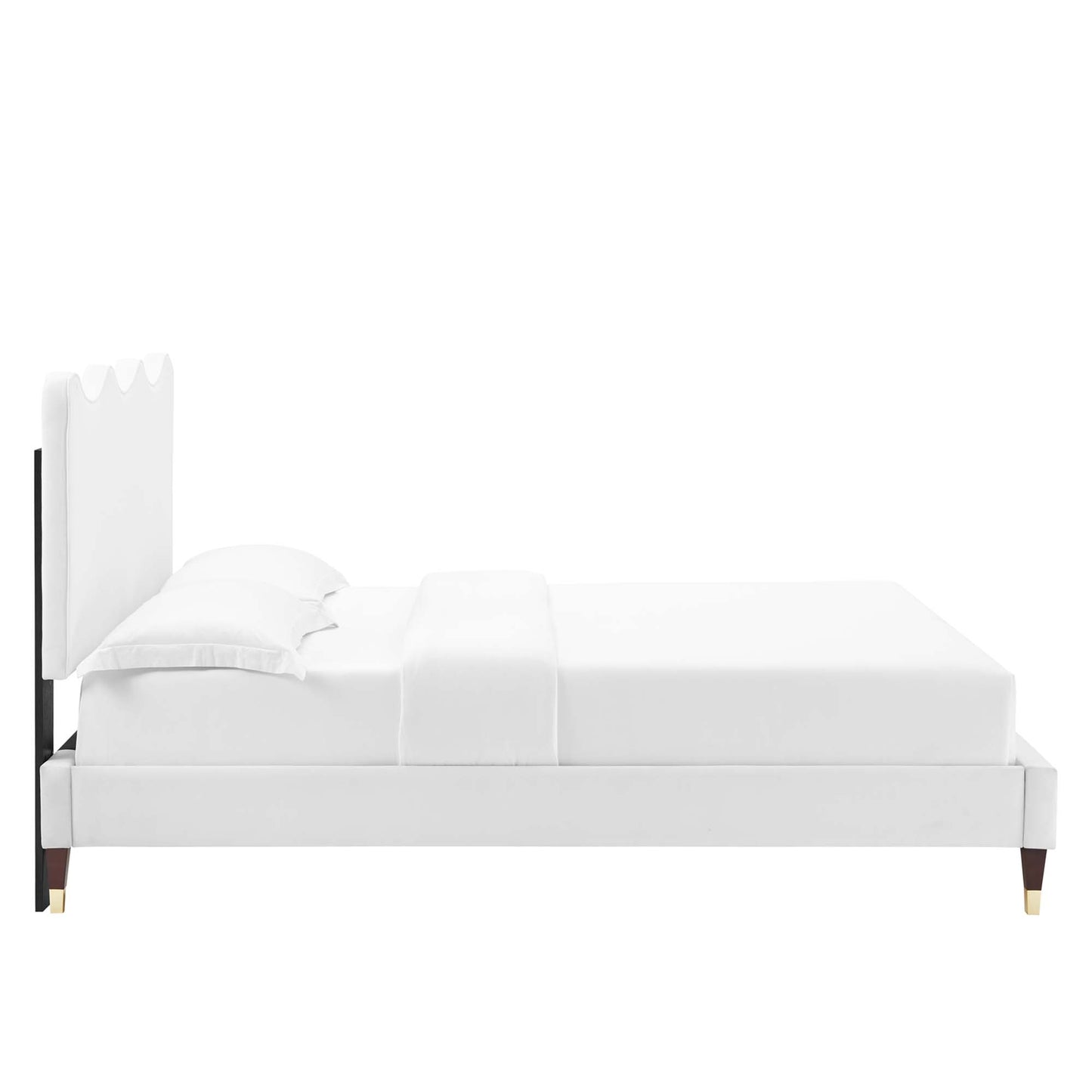 White upholstered platform bed with scalloped headboard, black accents and gold-tipped legs.